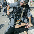 Photo of demonstrator being held to the ground.